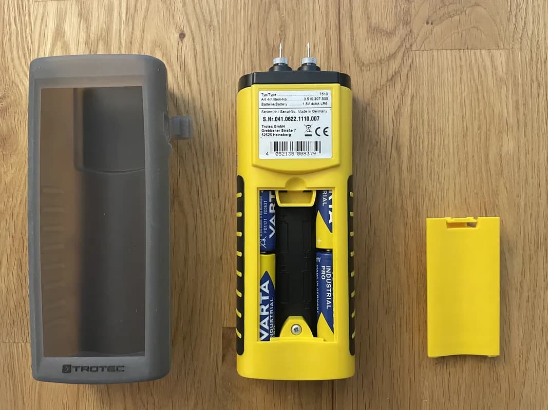 Das TROTEC T510 liegt mit aufgeschraubtem Batteriefach auf dem Tisch.
